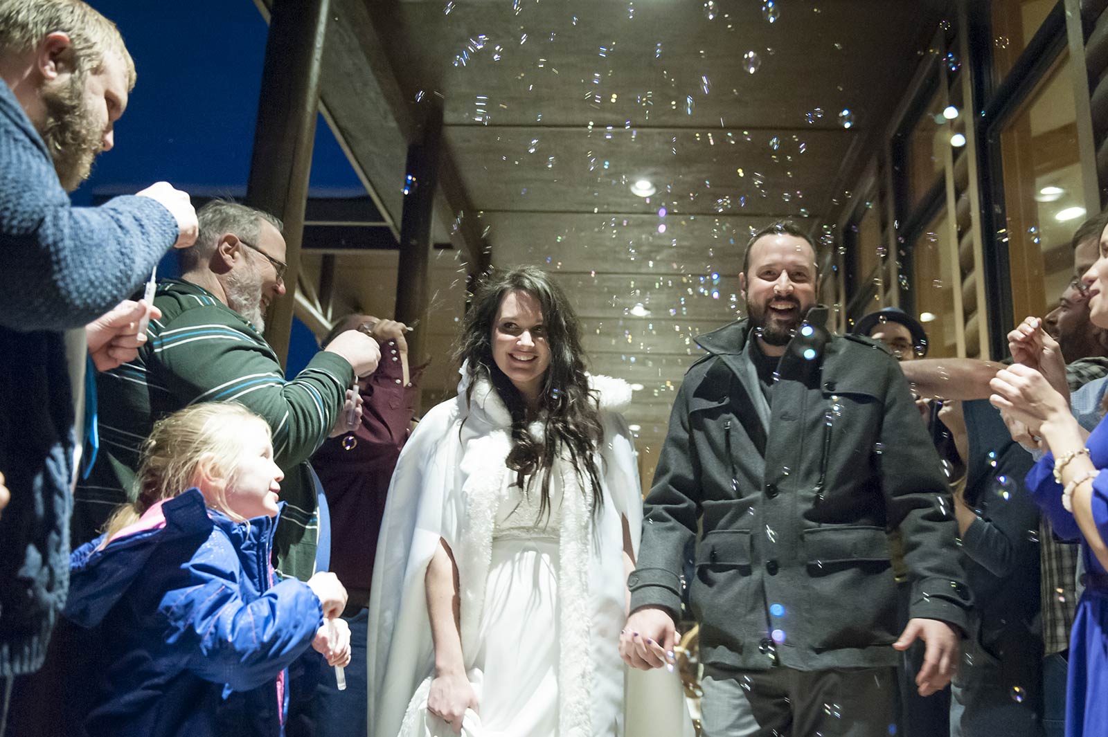 Couple walking out under bubbles