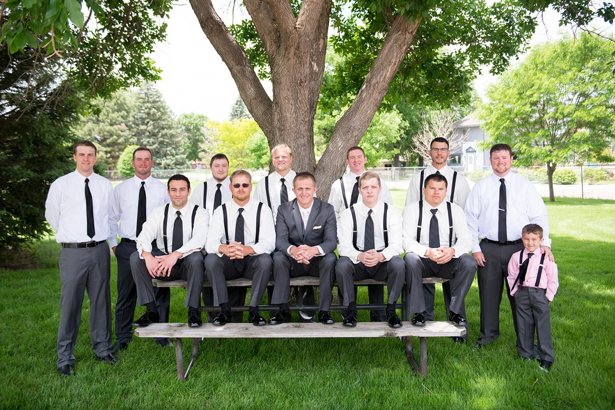 Groomsmen sitting in a park